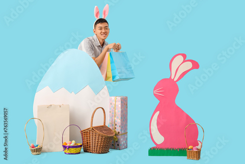 Young Asian man in bunny ea...