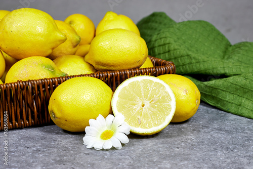 halfah basket full of lemons on wood table with plastic squeeze, Gardening concept, lemonade  photo