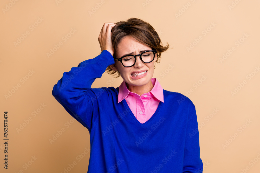 Photo portrait of attractive young woman touch head suffer headache wear trendy blue clothes isolated on beige color background