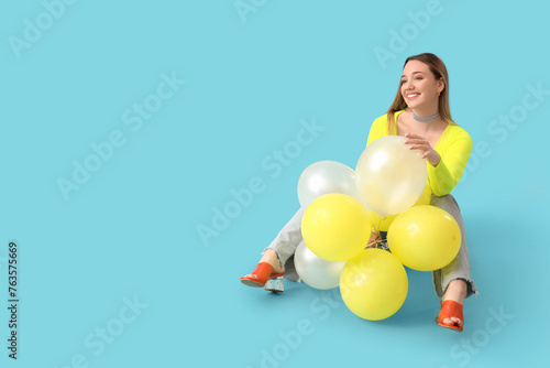 Young woman with balloons s...
