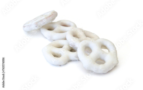 White chocolate covered pretzels on white background 