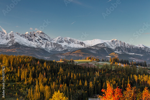 Autumn in the mountains. Sunrise in Gliczarow Górne with a view of the snow-covered Tatra Mountains.