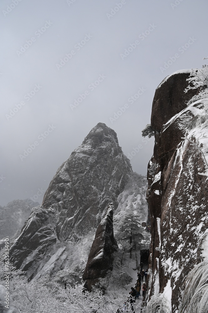 Beautiful view of snow-covered mountain with trees in a winter snowscape in Huangshan, China