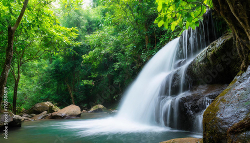 Enchanting waterfall in lush natural forest serene landscape where water cascades over rocks amidst green foliage creating tranquil travel destination perfect for outdoor photography and environmental