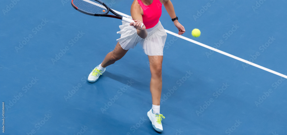 Naklejka premium Woman playing tennis on blue floor. Horizontal sport poster, greeting cards, headers, website