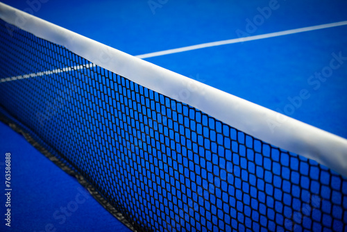 Paddle tennis and tennis net on blue court. Tennis competion concept. Horizontal sport poster, greeting cards, headers, website © Augustas Cetkauskas