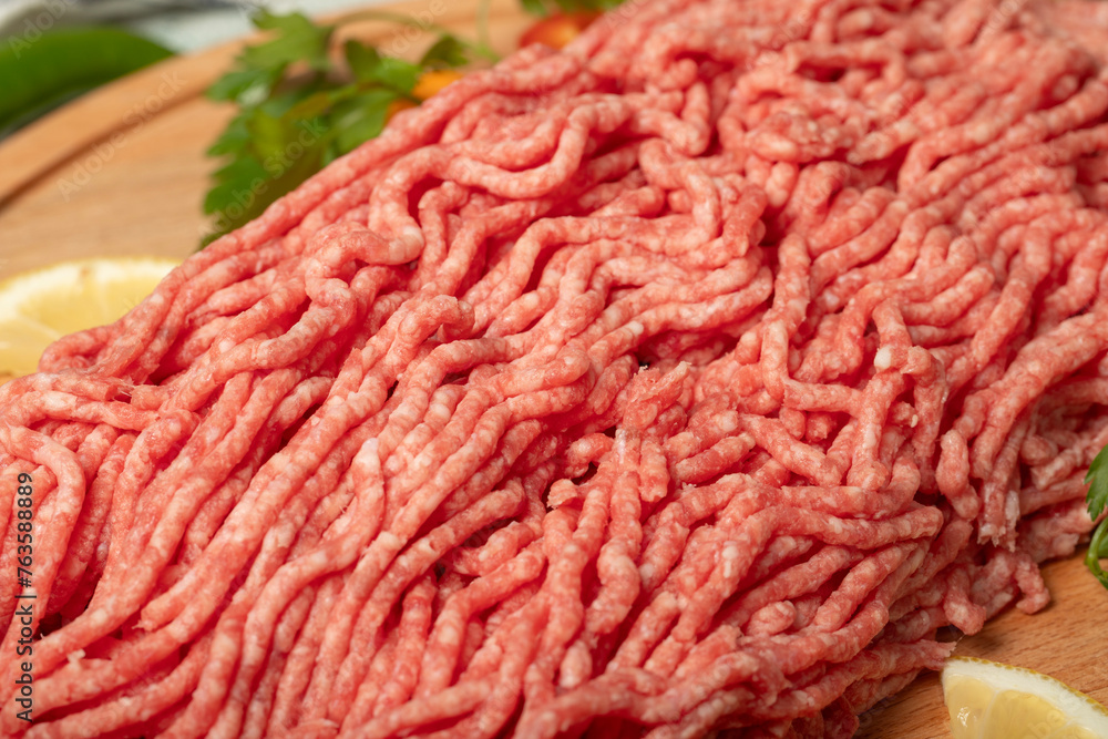 Ground beef. Raw ground beef or minced meat on wood serving board. Close up Ground beef. Raw ground beef or minced meat on wood serving board. Close up