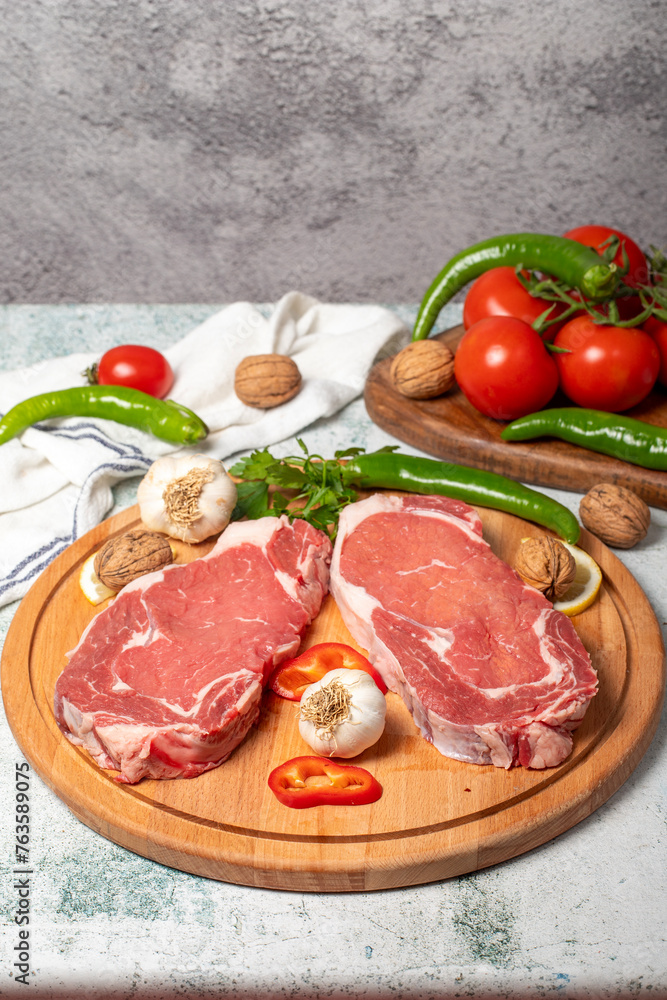 Beef entrecote. Raw beef ribeye on wood serving board. Close up