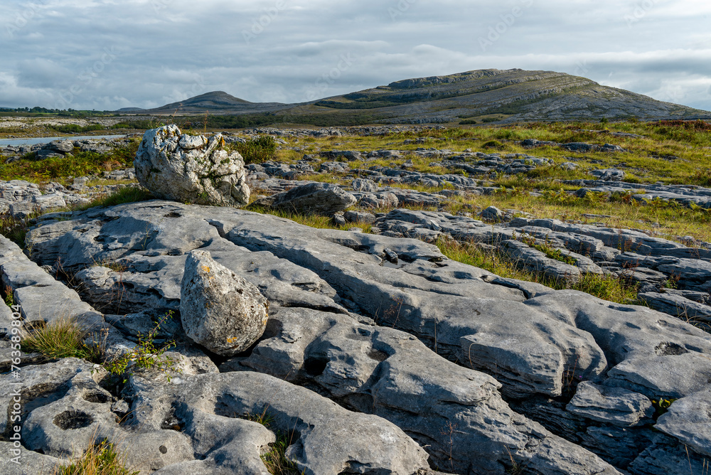 Bizarre limestone pavement in the Burren National Park, Mullaghmore and Slieve Rua hills in the background, County Clare, Ireland Bizarre limestone pavement in the Burren National Park, Mullaghmore and Slieve Rua hills in the background, County Clare, Ireland