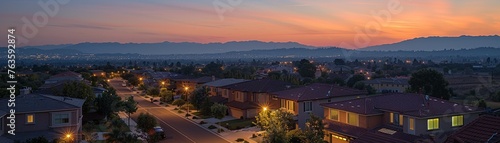 Visualize a serene suburban neighborhood at dusk, showcasing how nanotechnology has revolutionized energy efficiency and sustainability through solar-powered homes and eco-friendly smart gadgets