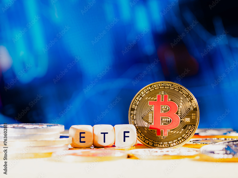 Bitcoin ETF. coin stands against a blurred blue background with financial graphs. Other coins are scattered around it. The image conveys a modern approach to finance and investment on stock marketa