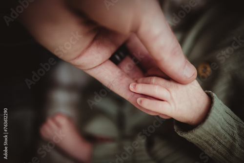 parent father and baby's hands