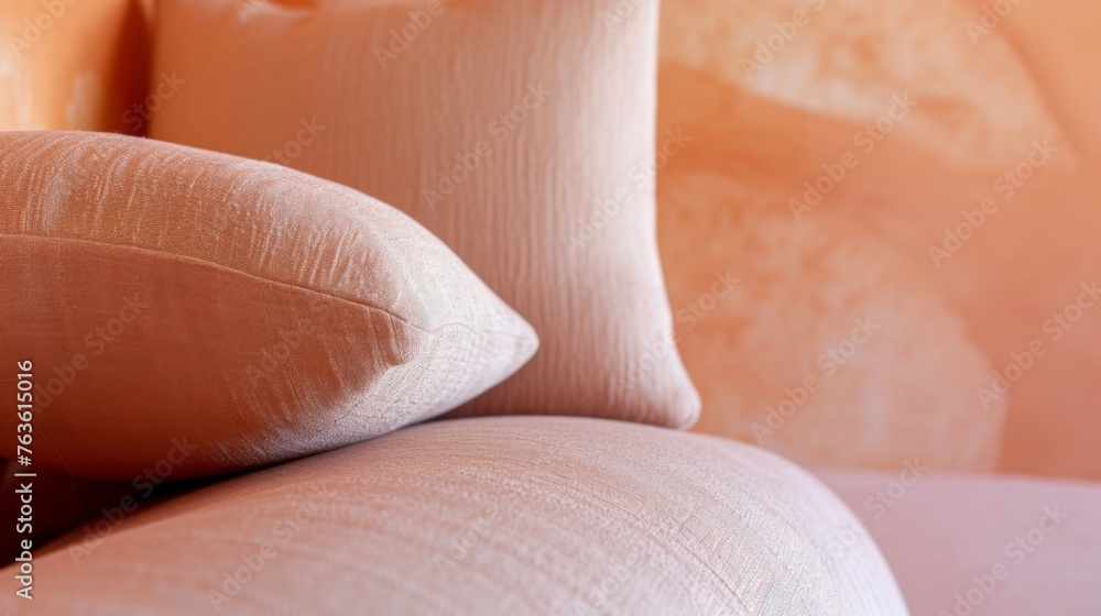 Fototapeta premium Fashionable fabric texture and interior design in Color of the Year 2024 Peach Fuzz. Modern sofa adorned with soft, peach-colored cushions. Detailed texture of the fabric exudes luxury, enhancing the
