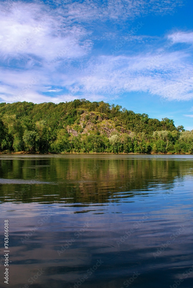 Forrest's river bank is reflected in the still river water. Forrest's river bank is reflected in the still river water.