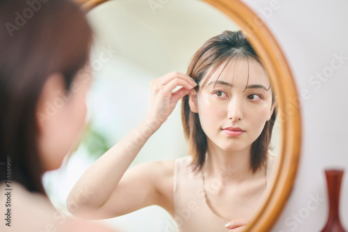 Photos 鏡の前でヘアセットをする20代女性