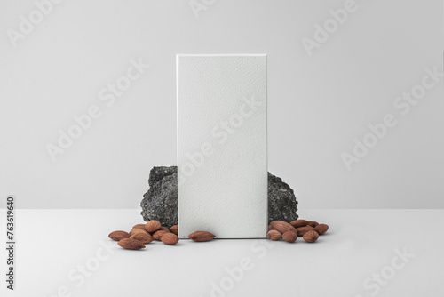 Matte white chocolate box packaging. Blank cardboard mockup. Textured paper. (real photo) Quality minimal 3D render. With rock and Armands (ID: 763619640)