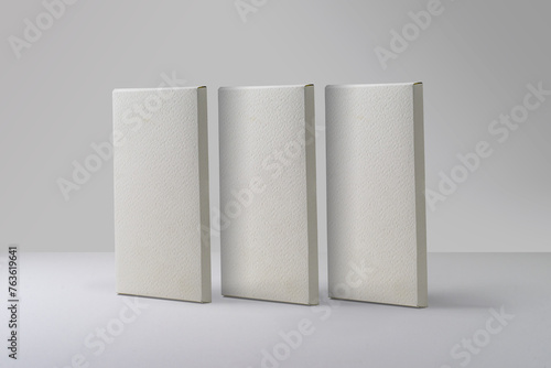 Three matte white chocolate boxes packaging. Blank cardboard mockup. Textured paper. (real photo) 3D render (ID: 763619641)