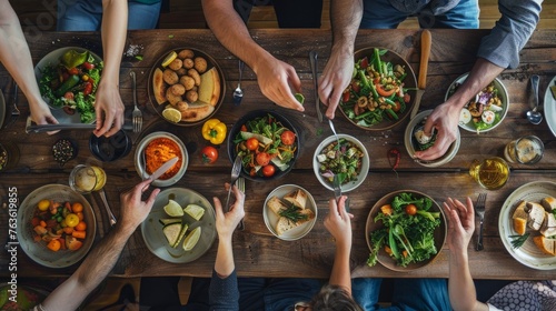 Group of friends having great time, eating lunch together. photo