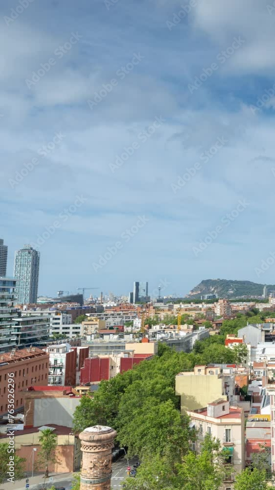 Timelapse of clouds moving above skyscrapers and towers in Barcelona, Spain in vertical Timelapse of clouds moving above skyscrapers and towers in Barcelona, Spain in vertical