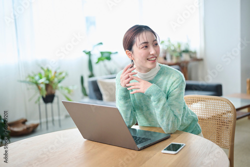 パソコンでの作業中に談笑する20代女性