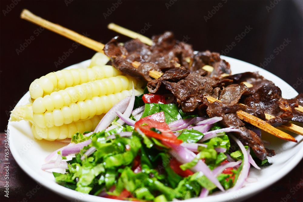 Typical peruvian food - grilled beef with corn and salad. Typical peruvian food - grilled beef with corn and salad.