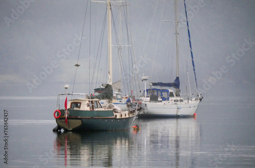 Boats in front of the shore of Cowichan Bay during a winter season on Vancouver Island in British Columbia, Canada