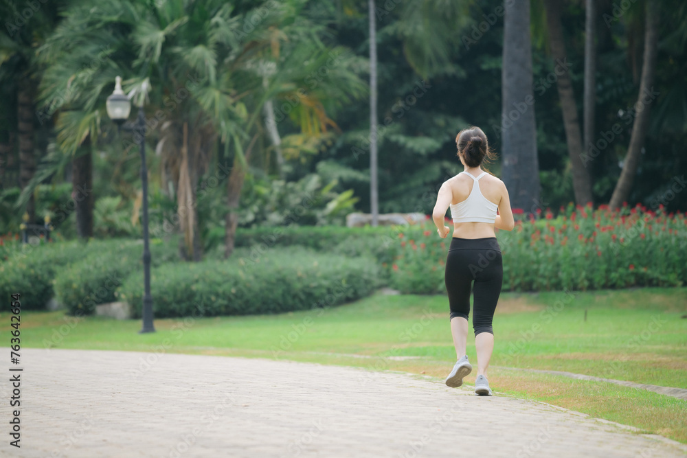 asian woman jogger running in green nature public park. asian woman jogger running in green nature public park.