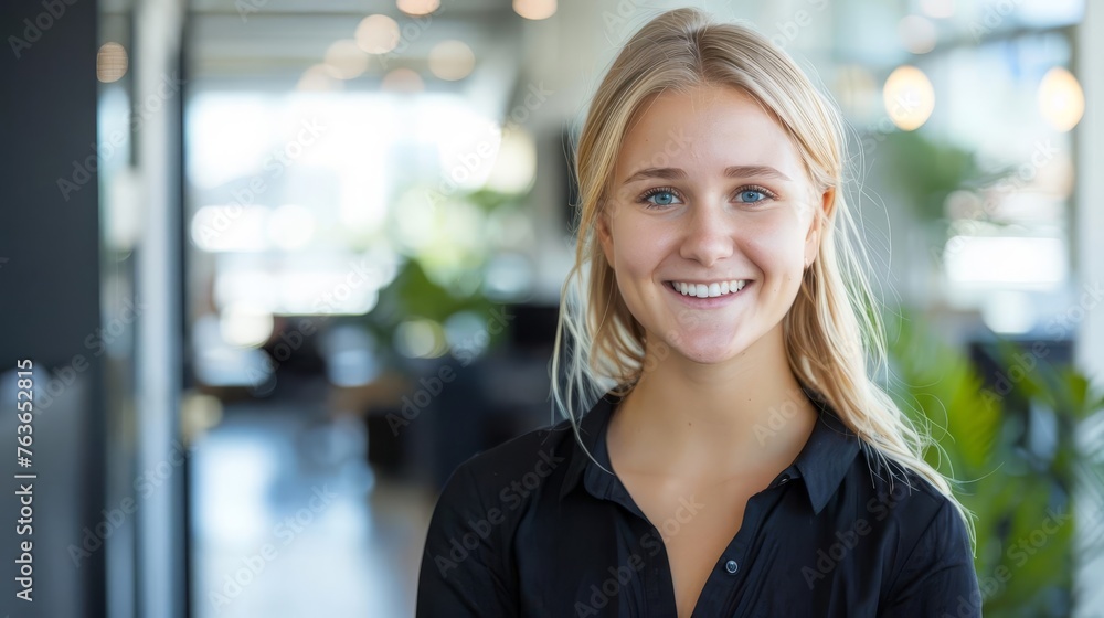Confident young blonde businesswoman smiling at camera in modern office, leadership portrait, professional photography Confident young blonde businesswoman smiling at camera in modern office, leadership portrait, professional photography