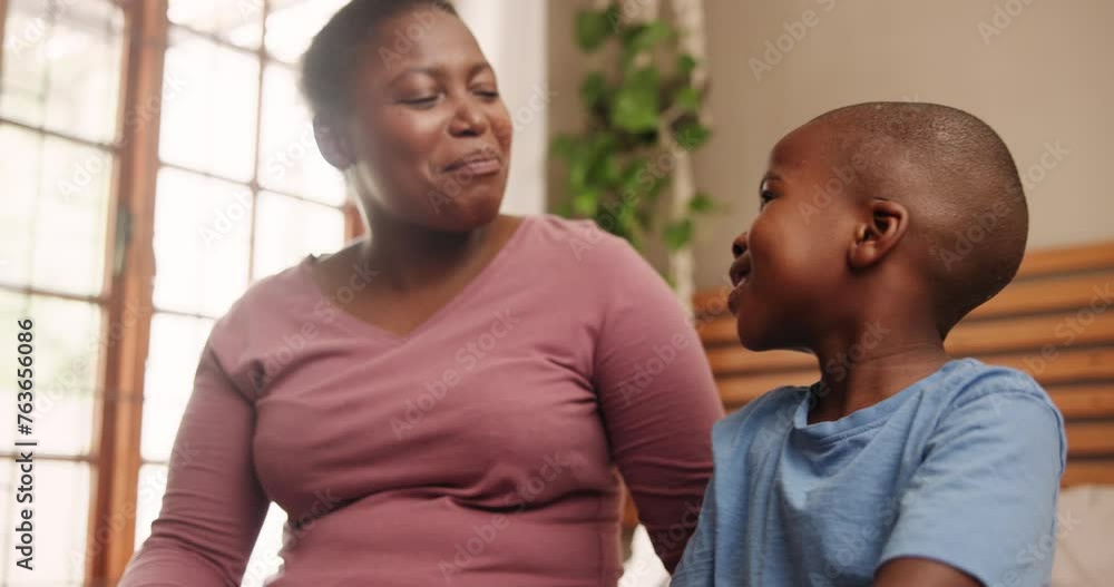 Conversation, talking and mother with child in bedroom for bonding, loving relationship and happy together. Black family, love and African mom with young boy for speaking, chatting and relax in home Conversation, talking and mother with child in bedroom for bonding, loving relationship and happy together. Black family, love and African mom with young boy for speaking, chatting and relax in home