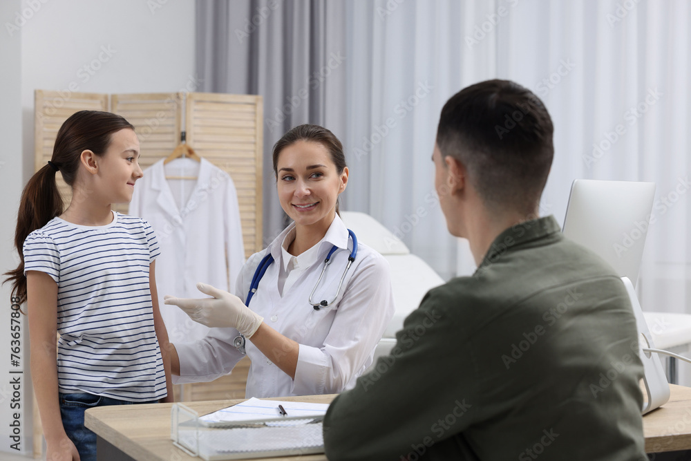 Gastroenterologist examining girl with stomach ache in clinic Gastroenterologist examining girl with stomach ache in clinic