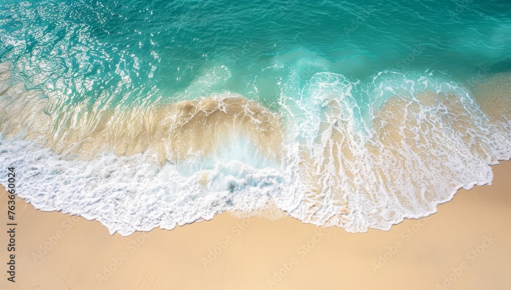 Tranquil waters and sandy beach create a serene and inviting top-down seascape.