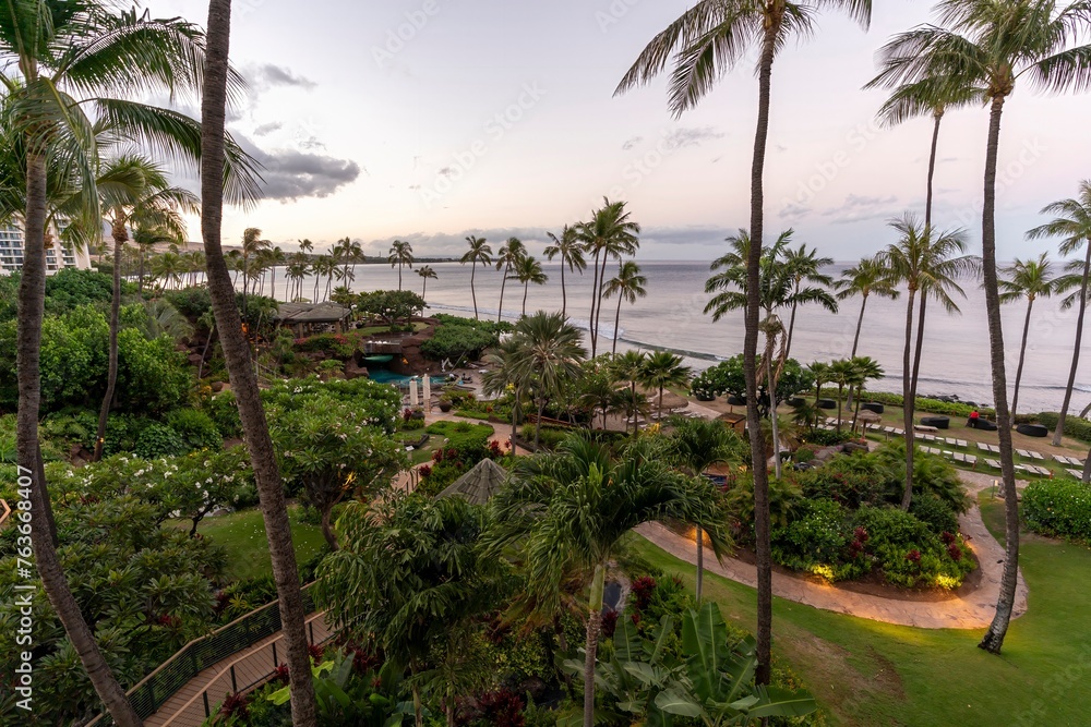 Looking out upon the crystal blue Pacific Ocean and towering palm trees of Ka'anapali Beach, located in Lahaina, Hawaii on the island of Maui.