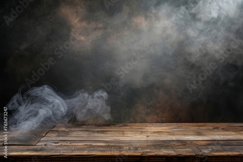 A haunting haze of smoke drifts over a weathered wooden table, shrouded in darkness for a captivating visual effect.