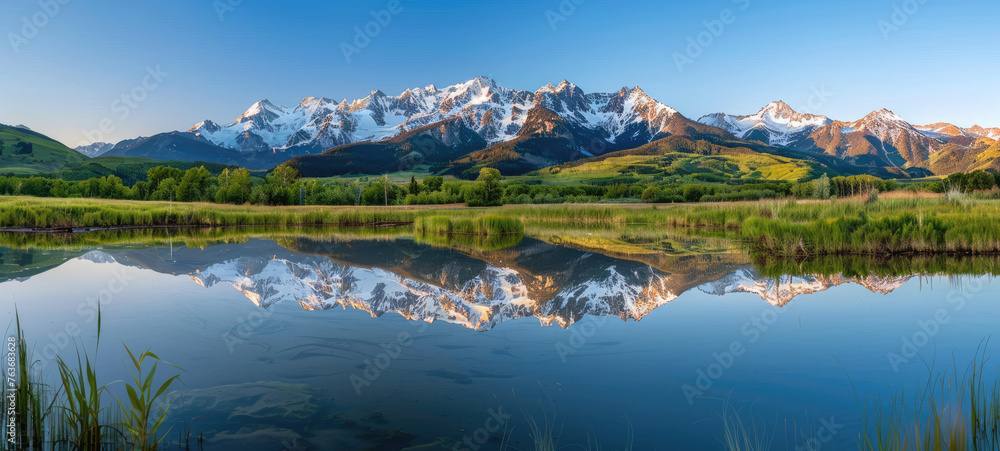 A panoramic view of the Briesins mountain range with snowcapped peaks reflecting in still waters