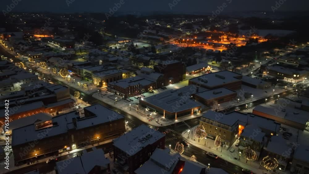 custom made wallpaper toronto digitalSnow covered town at night. Aerial orbit shot above lit up main street with Christmas lights on trees and quaint buildings.