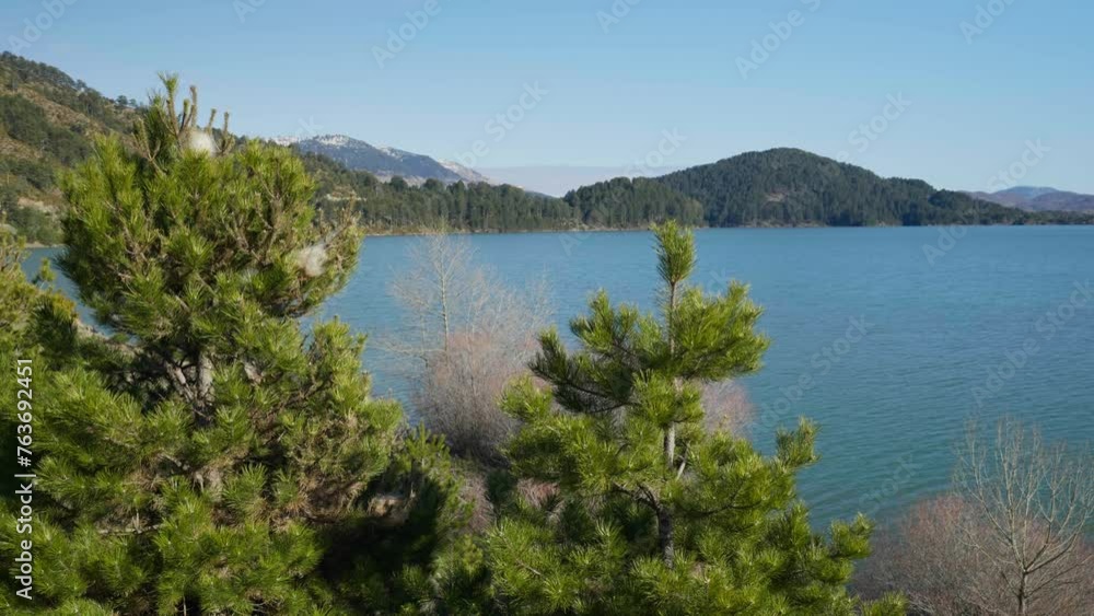 Panning right to reveal Aoos spring Lake Metsovo Greece Sunny winter day Panning right to reveal Aoos spring Lake Metsovo Greece Sunny winter day