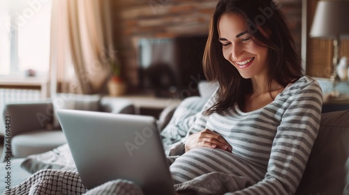 pregnancy, technology, people and expectation concept - happy pregnant woman with laptop and