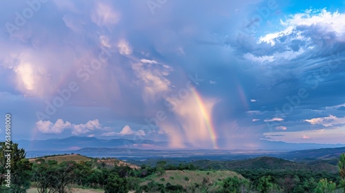 Amidst the chaos and fury of the monsoon rains a majestic rainbow stretches across the sky offering a brief moment of respite in the midst of the storm.