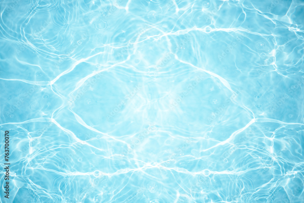 Bluewater waves on the surface ripples blurred. Defocus blurred transparent blue colored clear calm water surface texture with splash and bubbles. Water waves with shining pattern texture background. Bluewater waves on the surface ripples blurred. Defocus blurred transparent blue colored clear calm water surface texture with splash and bubbles. Water waves with shining pattern texture background.