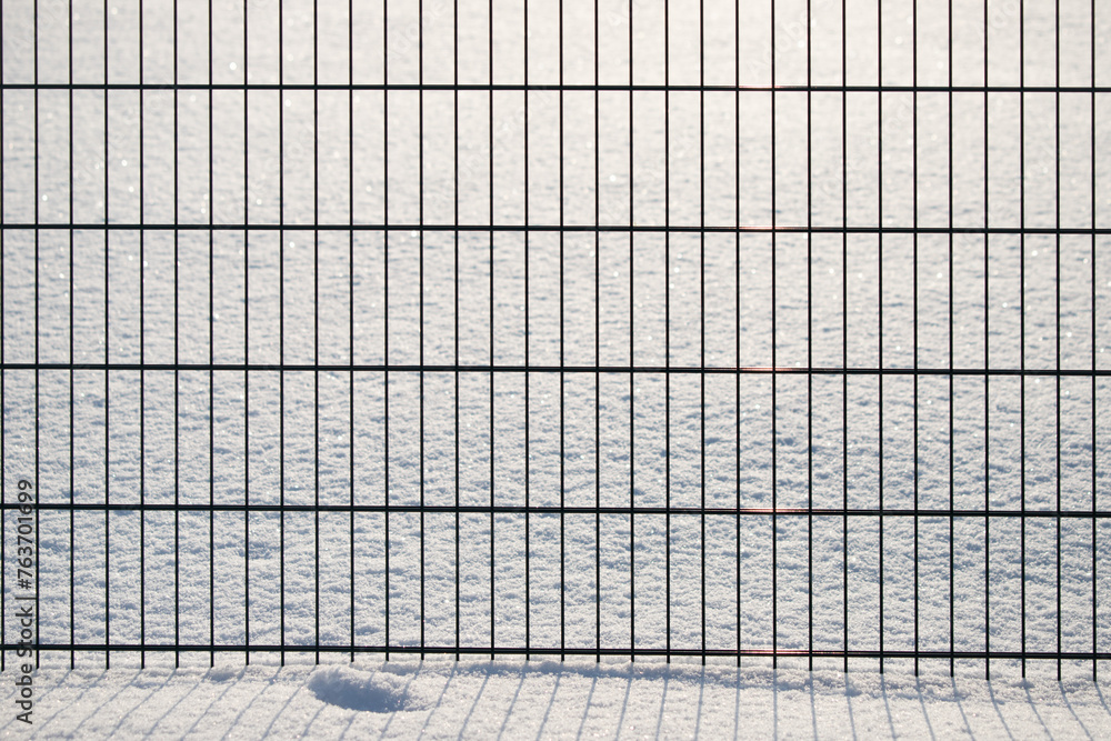 Green metal fence in winter in the snow. Green metal fence in winter in the snow.