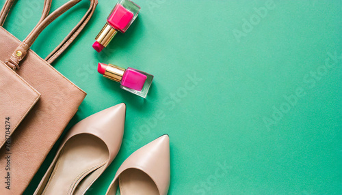 Flat lay woman's accessories bag, high heels, lipsticks on green mint background. copy space for text; top view