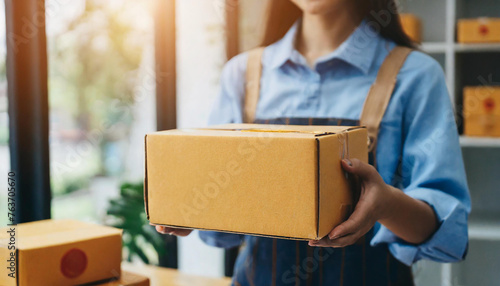 Startup small business entrepreneur or freelance Asian woman holding parcel box, Young success Asian woman with her online marketing packaging box and delivery