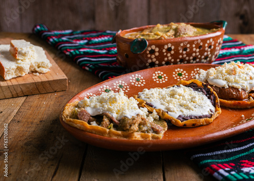 Sopes of chicharron in green sauce and red sauce. Mexican food. photo