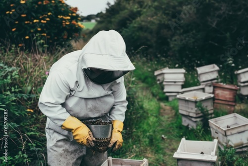 Beekeeper Examining Beehive Frames in Apiary with Protective Gear and Smoke Can for Sting Prevention in Sunny Day, Agriculture and Beekeeping Concept
