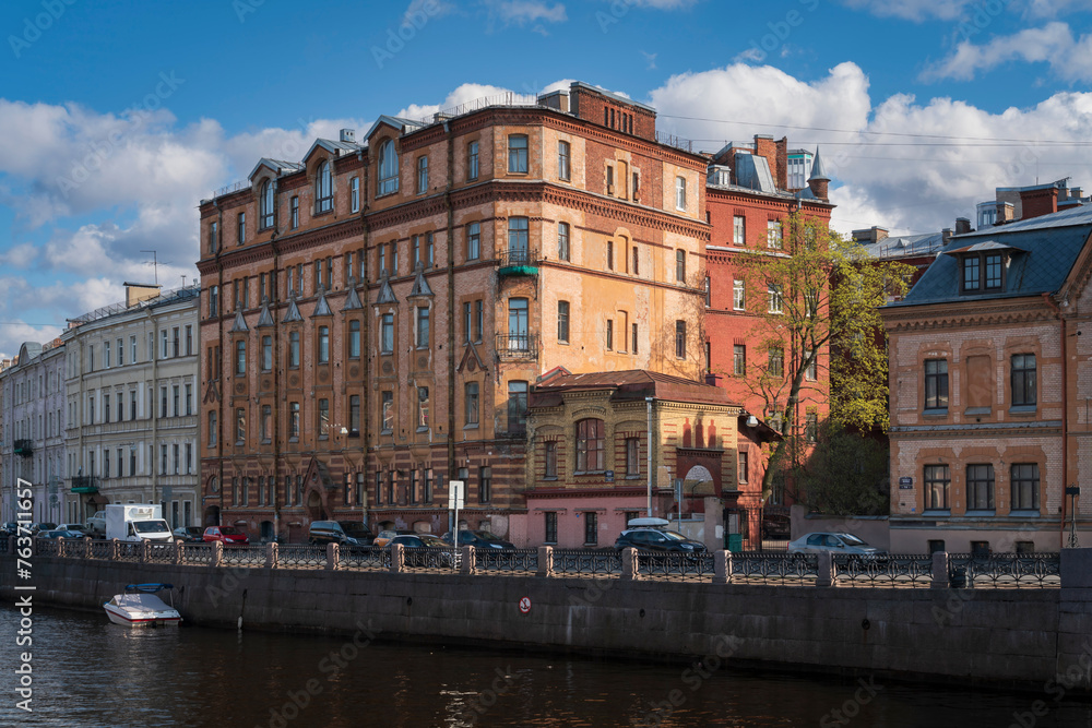 View of a residential building on the Moika River embankment on a sunny day, Saint Petersburg, Russia