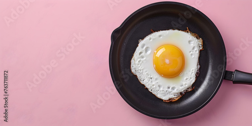 Fried egg with ingredients in cast iron frying pan on pink background, 