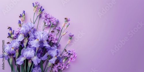 Exquisite Purple Iris and Delicate Pink Flower Bouquet on Solid Purple Background  Elegant Floral Display for Various Occasions