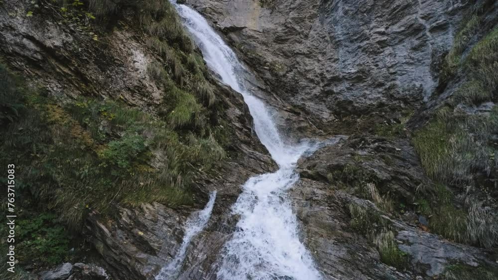 waterfall on a mountain river on a hiking route in the Alpine mountains. Dolomites at autumn waterfall on a mountain river on a hiking route in the Alpine mountains. Dolomites at autumn