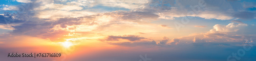 Gentle real sky with sun - Pastel colors - Panoramic Sunrise Sundown Sanset Sky with colorful clouds. Without any birds.  Natural Cloudscape. Real photo. Long panoramic