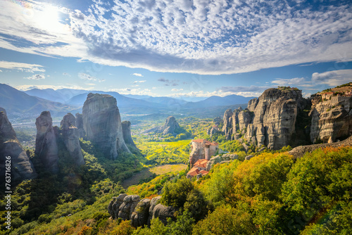 Meteora, Greece. Panoramic landscape of Meteora, Greece at romantic sundown time with real sun and sunset sky. Meteora - incredible sandstone rock formations.   Greece, Meteora © Taiga